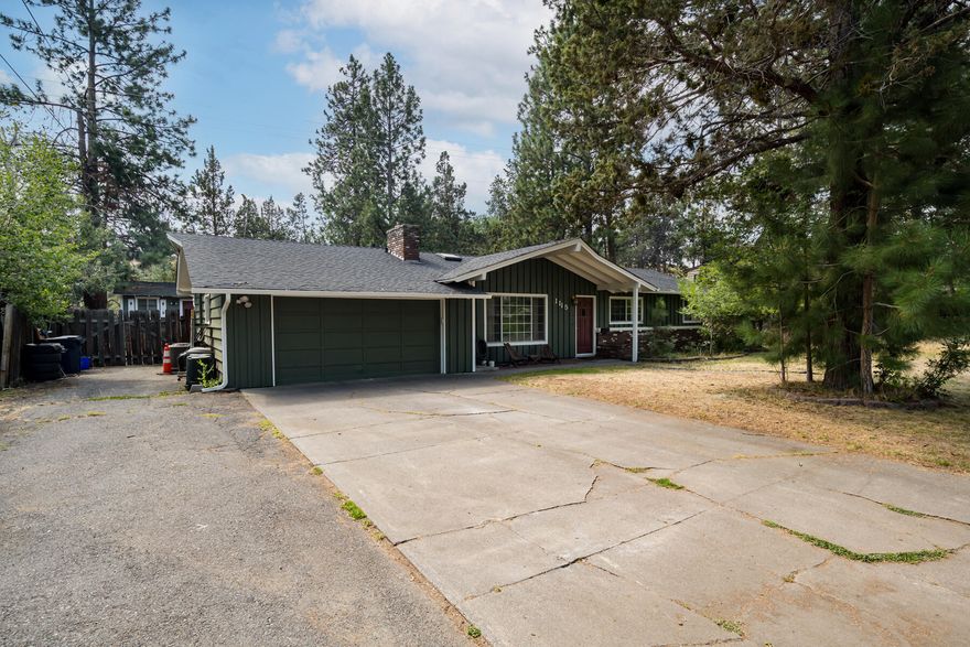 Nestled on nearly a quarter acre, this single-level home backs directly to Coyner Trail, with Juniper and Ponderosa Parks just a 15-minute walk in either direction. Your backyard abuts to City land, ensuring lasting privacy. Highlights include fresh exterior paint, a new furnace, newer AC, original hardwood floors in the living room, and a spacious primary suite with a gas fireplace and a ductless mini-split for comfort. In addition to a back patio, the property offers multiple storage sheds, a two-car garage, and RV parking. Both Bear Creek Elementary and Bend Senior High are within walking distance, and quick access to Franklin Ave puts you in downtown Bend in just 7 minutes.