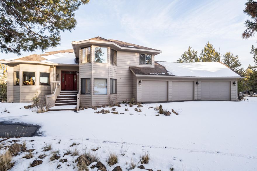 This captivating home is for the discerning buyer who is looking for plenty of charm, a unique layout creating the perfect amount of separation and space for family to spread out or for hosting guests. The main floor consists of a dining, living, and family room with a cozy pellet stove and deck through double glass doors, a bedroom, full bath, and mud room that leads to the garage. The garage is a 1,095 sq ft, 3-car garage with 10' wide doors and storage galore! The finished basement is currently being used as a game room but could be an office with its own private entrance. Upstairs enjoy a spa-like primary suite with jetted tub, tile shower, double vanities and spacious walk-in closet. 2 more bedrooms, a full bath, a half bath, and a room used as a 5th bedroom without a closet rounds out this floor.  Enjoy panoramic easterly views from the home situated on over 1 acre of land, offering privacy without losing the convenient proximity to downtown, hiking trails, biking, and the river!