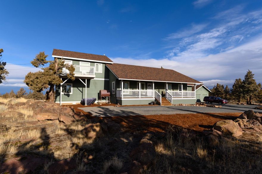 Nicely remodeled and updated single level layout w/a loft/office upstairs on 2.75 acres perched at the very top of Long Butte with panoramic 360-degree views. Click the virtual media link for a narrated video walkthrough w/aerial drone footage. The home has a heat pump, AC, a wood stove, & an oil monitor heater. The great room is open w/vaulted ceilings & Cascade Mountain views. The new kitchen has granite & juniper countertops along w/a breakfast bar & stainless appliances.  All the hardwoods in the great room are brand new as are the carpets throughout. The bonus room has a bar, fireplace, & a beautiful view through two windows on each side of the TV. Above the bonus there a bonus room/office w/a private deck. The master suite is spacious, & the master bath has a jetted soaker tub and a tiled shower along w/an enclosed toilet & double walk-ins. The detached garage has two doors & an attached storage shed. The home also has a RV spot with water & power but no sewer dump.