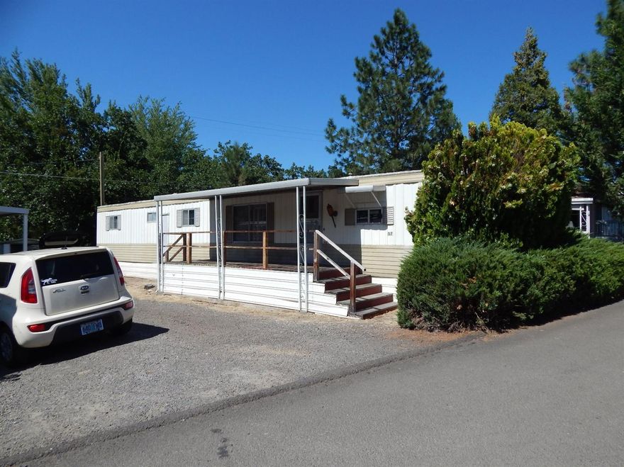 LOW COST LIVING is possible in Ashland. If two will do, then come visit #17 in Bear Creek Mobile Park. This 2 bedroom, 1 bath home is super for a single. Space rent here is only $370 per month & includes water, sewer & garbage. The home backs up to the park's huge green space. A neighbor a few doors away has a back deck built to enjoy this woodsy setting. There are all the 1970s touches here: a gas cook top & gold toned refrigerator in the kitchen & warm wood paneling throughout the rest of the home. The water heater was replaced in 2009 & a new gas furnace installed in May. Here's your economy package for only $20,000!