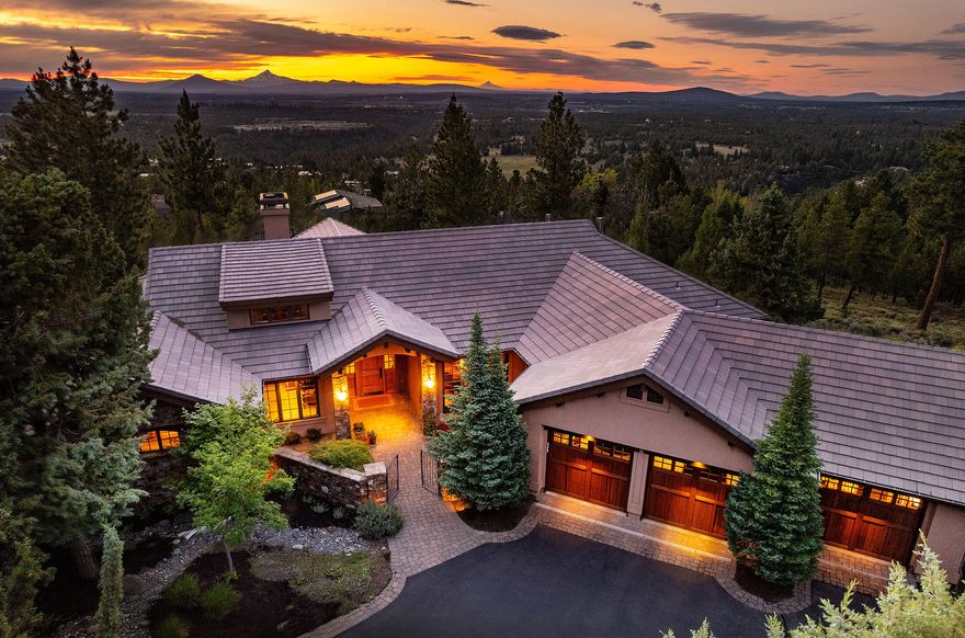 Enjoy stunning Cascade views from this beautifully crafted home on Awbrey Butte. The main level features a spacious primary suite w/ heated floors in the bathroom & 2 additional en suites. Rich alder woodwork—including beams, cabinetry, doors, & trim—adds warmth throughout, complemented by matte-finish hickory hardwood floors. The great rm boasts vaulted ceilings, built-ins, & an Elk Mountain stone fireplace. A chef's dream, the kitchen includes a Gaggenau steam/convection oven, Wolf 36'' six-burner dual fuel range, Sub-Zero wine fridge, Bosch dishwasher, 42'' built-in KitchenAid refrigerator, leathered granite countertops, & walk-in pantry. Downstairs offers a wet bar, sink, & full bath—ideal for entertaining or guests. The oversized 3-car garage includes built-in cabinets. Enjoy outdoor living on the paver patios w/ a tranquil waterfall feature. Luxury & comfort in one exceptional home.