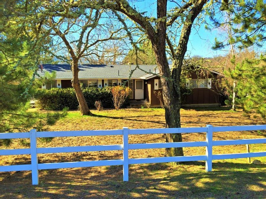 Your slice of Southern Oregon heaven! Close in, highly desirable location yet still in the country w/ 1.12 (TID irrigated) acres. The house sits tall next to the large 30x30ft Shop at one end of the property, leaving a gorgeous green pasture at the other. Great little hobby property/farm. The house has Great bones. Main level has 3 large brms, 2 full baths, Kitchen, dining rm & warm friendly living rm w/ corner fireplace perfect for cold winter nights, hot cocoa & grandpa's stories. Summer time spend the evenings swinging on the covered deck w/ beautiful Garden & valley view. The lower level comes complete w/ 2nd full kitchen, Large family rm w/ fireplace, full bath & patio entrance. Perfect for guests, big gatherings or In-law suite. Ideal property for the mechanic, woodworker, metal or clay worker w/ 30x30 ft Shop w/ tall 12 ft slider door. Or use as RV storage or Barn. Also, has a greenhouse on the side, ready for your green thumb. A million options here, come see what's possible.