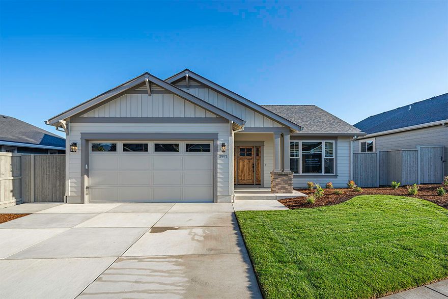 New construction home in the Middlefork Creek subdivision in East Medford by Mahar Homes, Inc. This house has never been lived in due to the seller having a change in plans. The seller did install very nice Hunter Douglas window coverings. It is a beautifully crafted home, featuring custom cabinets, quartz countertops, and rich hardwood flooring throughout the main living areas. The bathrooms and laundry room are adorned with elegant tile, while vaulted ceilings and a gas fireplace create a cozy ambiance in the great room. The primary suite offers a spa-like bathroom with a double vanity and sliding doors leading to a private patio. The property includes a fully fenced, landscaped yard and a 2-car garage. Built with quality in mind, the home boasts Hardie plank siding, Milgard windows, and is Earth Advantage certified for energy efficiency. Listing agent is related to seller.
