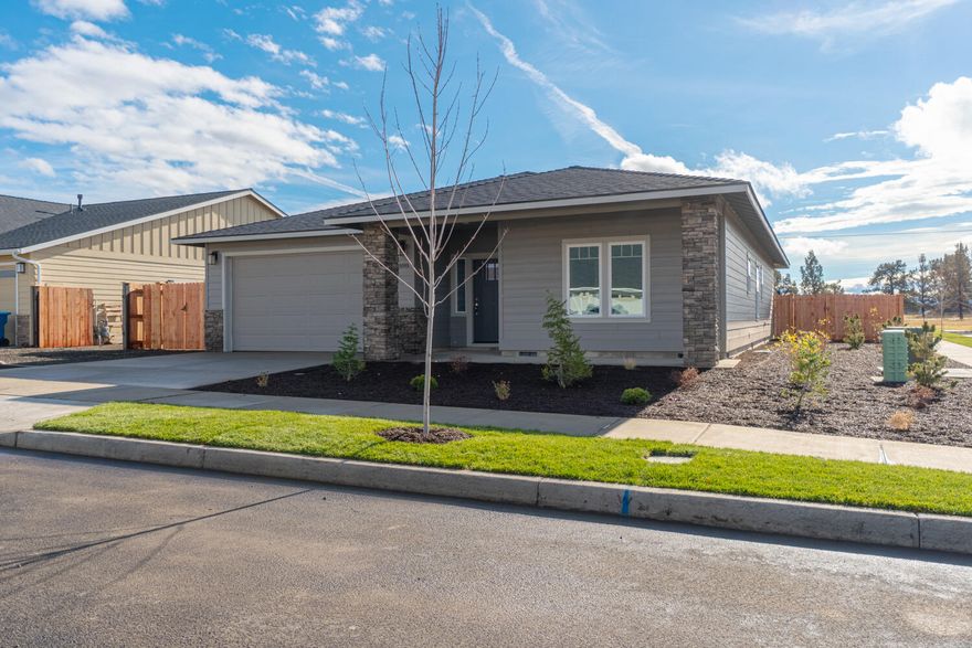 Looking for that perfect home on a big lot w/ views but near stores too? Now complete - quick close possible. Located on the Bend side of Redmond w/Cascade Mtn Views. Spacious living both inside & out, w/plenty of room for entertaining. Vaulted Great Room plan w/open Kitchen, tons of cabinetry & prep space on the slab Quartz counters. Neat & tidy full height tiled back splash, SS appliances & farm sink. Living space offers a cozy corner Gas burning fireplace w/stylish accents & room for gathering. Desirable Master separation, walk in closet, step in shower, tiled floors & dual vanities. 2 additional guest rooms off the entry w/full bath. Laundry room w/storage & folding table too! Durable wood look laminate flooring, carpet in the bedrooms & tiled baths. Gas forced air, A/C & back patio. Double garage, gated RV parking, fully fenced, fully landscaped w/auto sprinklers. Space for a shop or Casita ask for plans! Don't miss!  OPEN HOUSE Sat & Sunday