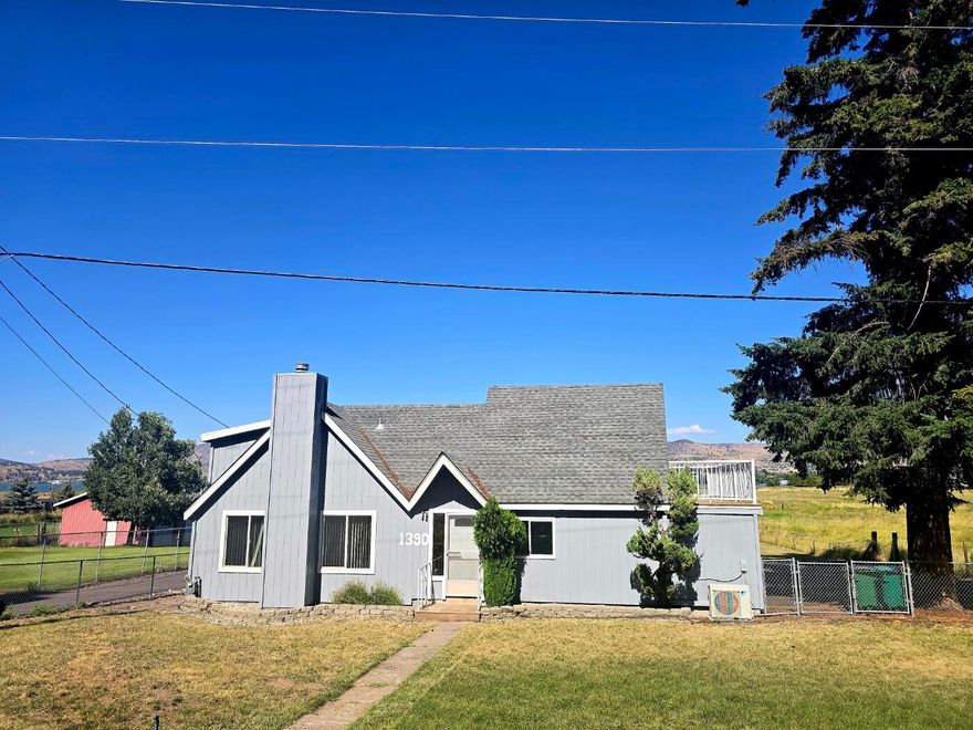 Dream Home with Stunning Lake Views!
Discover your perfect retreat in this spacious 3-bedroom, 2-full-bath home. Enjoy the impressive vaulted ceiling in the living room, complemented by a cozy loft.
Attached 1.5 Car Garage, Detached Carport,
Huge Barn/Garage -An incredible space for hobbies, storage, or a workshop, complete with an extra storage room.  Relax and unwind on the wrap-around deck or the balcony offering breathtaking views of the lake.