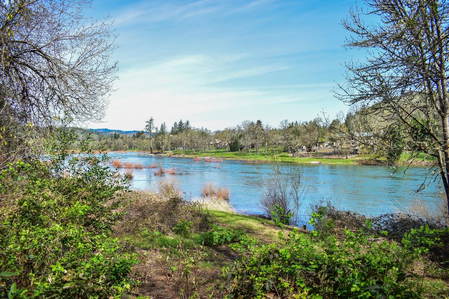 This custom designed home by the notable Portland Architect Saul Zaik is Pacific NW Modernism at its best. Zaik's homes are known for their unique ability to complement their surroundings.   Nestled on two tax lots and 24 acres, this is 6,042 sqft of natural wood and glass that fully appreciates the river & mountains views. Home has a park-like garden below with a variety of shade plants, including a massive Sequoia, that runs along approximately 500 ft of river, known for its steelhead and trout fishing. This home has lots of natural light, plenty of room for living or large entertaining! There's 2nd guest suite, additional in-law quarters with own entrance, attached oversized 2 car garage, detached carport & storage! Mid-acreage is flat/fenced corral & barn/shop area. Lower acreage is park-like garden area that runs along riverbank. Property has sophisticated self-contained water purification system. A unique property combines best of country living just minutes to town!