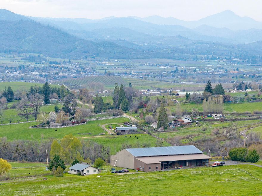 East Ashland hills dream! This 3-bed, 2-bath home set on 62.19 acres of irrigated land is a rare find. Offering a peaceful rural feel while being just minutes from downtown Ashland. The recently repaired 13,500 sqft barn provides ample space for animals, equipment, and storage. An attached office space with its own bathroom is perfect for a home business or guest quarters. Take in the breathtaking views of the surrounding landscape and experience the beauty of country living with modern conveniences.