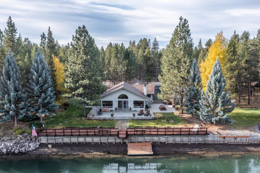 Single level river front beauty! This beautifully updated 4 bedroom/3bath with 2811 sf home boasts over 200 feet of Big Deschutes River frontage with large dock. Wonderfully appointed primary suite has a walk in closet, river views and access to the back through a slider. Bath has walk in shower, tub, dual vanities and extra storage. Two bedrooms are separated off an additional family/media room with full updated bath. Beautiful hardwood and tile floors are throughout the home. Kitchen and great room enjoy the warmth of a wood burning fireplace. Kitchen has granite counters, extensive island/breakfast bar, pantry and wine fridge for all your entertaining. Outside you'll find the hot tub, fire pit, garden with greenhouse, multiple RV hookups, RV dump, kayak/paddleboard racks, and more storage/workshop space. Outdoor living at it's best! Community includes multiple boat ramps or simply enjoy the river from your own backyard from this Central Oregon slice of heaven.