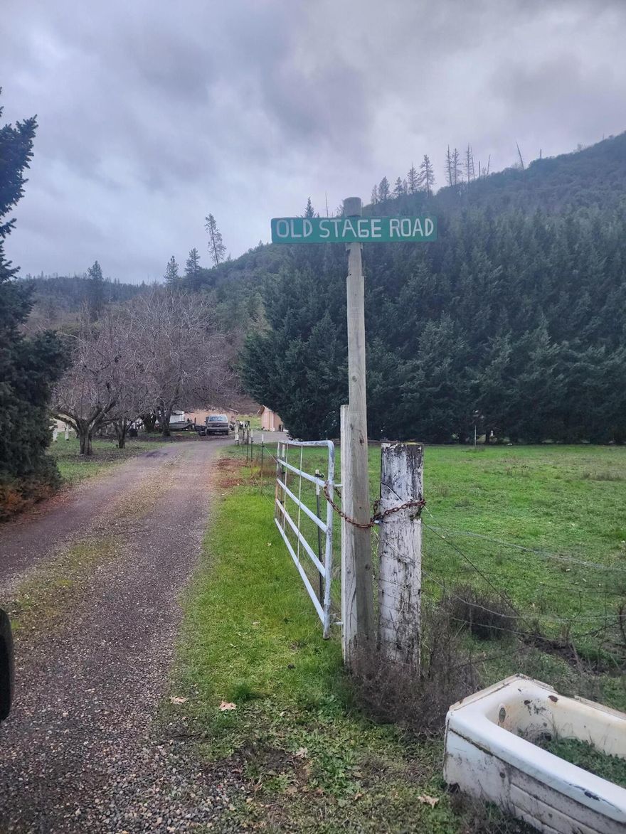 Investors opportunity located just minutes from town, close to I-5 exits.  Property has mature landscaping, fruit trees, beautiful big Landen fir trees for privacy. IRRIGATED. Hay pasture, large garden areas, fenced & cross fenced for livestock, horses. makes for a wonderful mini ranch. Property has separate building that would be perfect for a small business office, workshop, art studio or mother-law unit due dilligence with Jackson County Planning Department to use of the Property. Home needs updated and is in the process of being cleaned up. Dimond in the rough don't miss this opportunity.