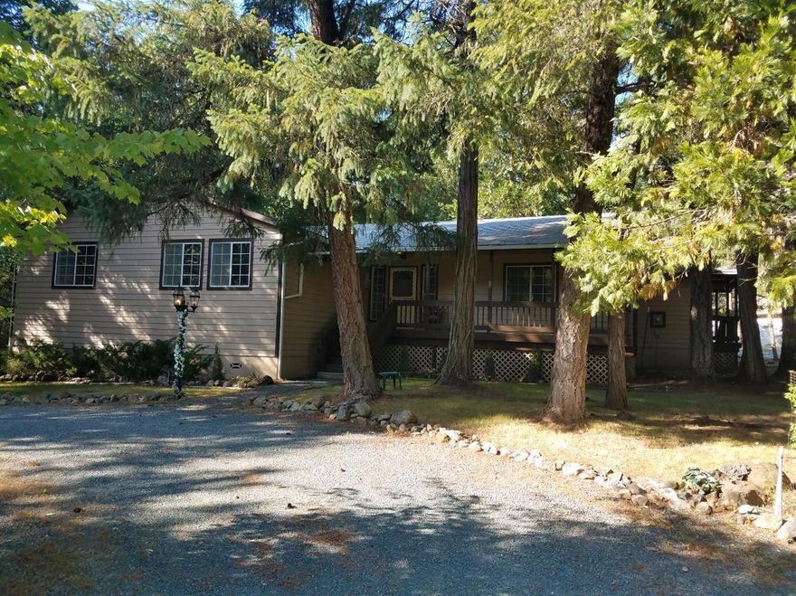 You'll feel welcomed as you drive in the driveway as it weaves its way back to your new home. 2700 square feet of comfortable living among the pines, firs and cedars on over 5 acres. The home has all new carpet, paint and granite counters in the kitchen ready for you to move it. It's got all you want with 3 bedrooms, 2.5 baths, living and family rooms as well as a large dining area, plus a large bonus room. You'll enjoy entertaining on the large covered deck. Got an RV? Large covered RV barn with power and water available. This one is calling.