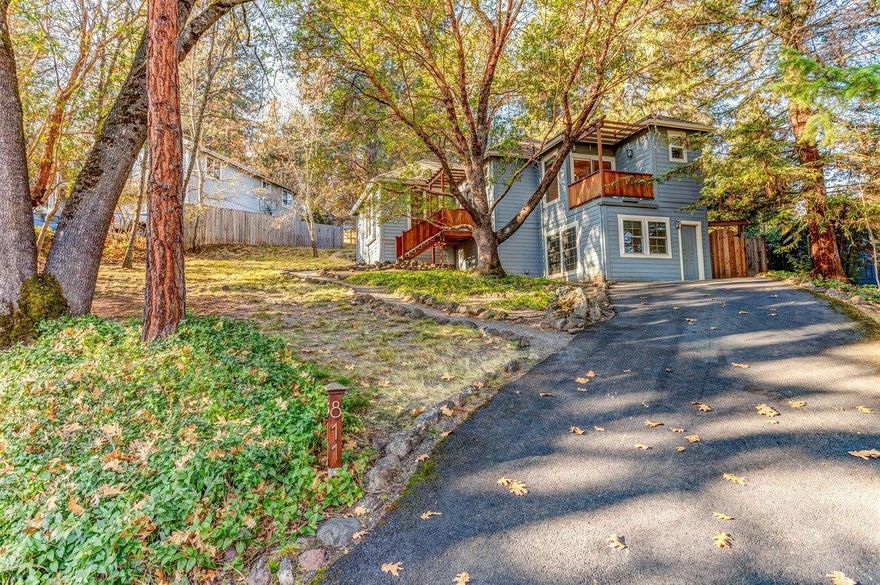 Very Unique and artistic Ashland home offers top end design & amenities in a fabulous, quiet above the Boulevard setting of mature madrone & fir trees all on a large 1/4 acre lot. Enjoy the wonderfully private and beautifully landscaped front and back yards with backyard upper deck overlooking lush foliage. Originally built in '98, there was an extensive remodel completed in 2006 now featuring an open, light filled central living room & wonderful kitchen, plus a one-of-a-kind master bath, Echo-Timber bamboo floors, custom lighting, Velux roof windows, double honeycomb Graber blinds plus a list of rare fixtures & amenities.2018 garage conversion into additional heated living space completes this wonderful home, now making it a true two bedroom & office or den.