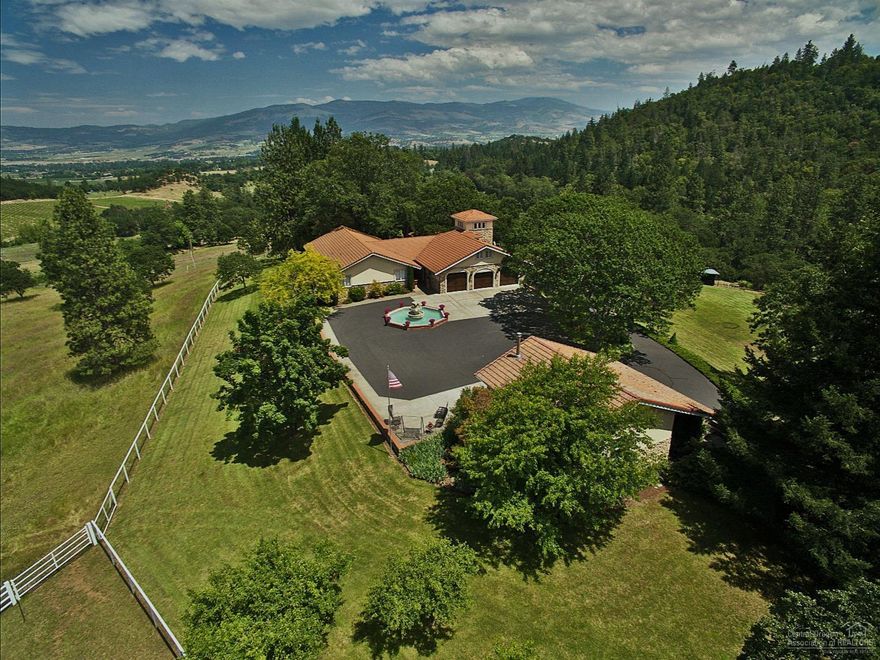 Equestrian estate. Enjoy a 37,100 SF lighted Roping Arena w/ custom Preifer panels, steer return alley, remote control chute w/ elevated stripping chute. Main house has indoor/outdoor gourmet kitchens, 4 BR, 4 baths, billiard room w/ bar and exercise gym. Wraparound deck w/ gazebo and hot tub. Upper shop is 672 SF w/ epoxy flooring. Machine shed has 5 bays w/ 2-car garage. 50 X 50 outbuilding has office, kitchen, bath, artist's studio and double motor-coach garage. Barn has 4 box stalls w/turnout corrals.