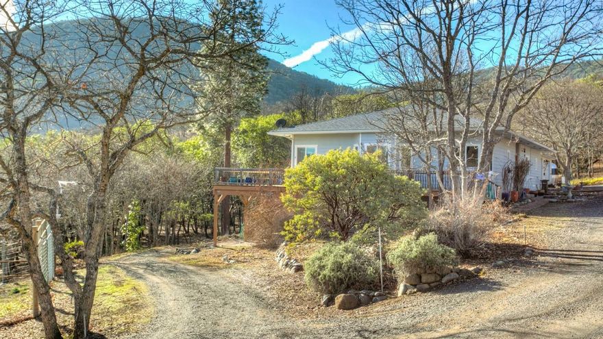 Magical, private, quiet, serene with wonderful views are just a few of the qualities of this 1998 build passive solar design 4 bedroom 3 bath home on 5 acres. 6 minutes from downtown Ashland yet a world away at the end of a private drive. The main house is 2630 sq ft with a large great room, gourmet chef's kitchen, an expansive deck for those summer evening enjoying family and friends, main level office and main level master bedroom with adjacent private outdoor luxury bath and shower. The downstairs has 2 bedrooms, 1 bath with a common rec area and adjoining deck. Outside there is a large greenhouse, passive solar hot water, established terraced irrigated flower gardens that bloom from May to November, a fenced 1200 sq ft raised bed garden with irrigation, a 2 car garage with a large shop and separate storage shed. There is also separate 2 story 496 guest cottage with private deck and lovely views, renovated in 2014. See video at https://youtu.be/fv4wrb8elok.