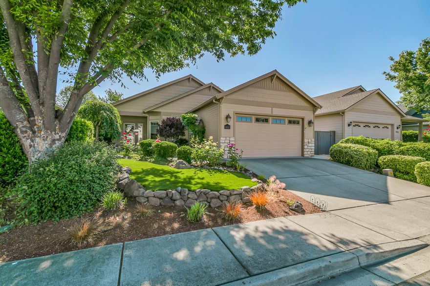 Beautifully maintained single-level home in a desirable East Medford neighborhood near golf, groceries, restaurants, and medical. Vaulted great room with gas fireplace, dining area with sliding glass door to concrete paver patio and fully fenced backyard, kitchen with granite dining counter, cabinets with custom built-ins and pull-outs, pantry, and updated appliances. Primary bedroom with ceiling fan, full ensuite bath with skylight, walk-in closet, double vanity, shower, and water closet. Two guest bedrooms with ceiling fans and full guest bath with tub shower. Solid-core fir doors and Hunter Douglas cellular shades throughout. Two car garage and laundry room with washer, dryer, utility sink. Mature ornamental trees and plantings, flowering bulbs, sunny gardening areas, drip irrigation, and low-maintenance turf lawns. Association dues of $30 per month cover common area landscaping. Seller credit available for carpet replacement. Inquire for details!