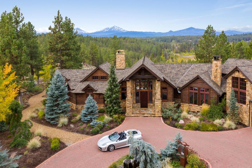 A true masterpiece of Pacific Northwest architecture designed to embrace the warmth of our National Park Lodges. The rustic luxury, elegance, and serenity of  Ravens Nest is a once in a lifetime opportunity. Sprawling gracefully on nearly 80 acres among the majestic pines, junipers and aspens of Central Oregon. This extremely private sanctuary offers complete immersion in the natural environment & unobstructed views of the Cascade range. Craftsman details include smoked hickory flooring, moss rock fireplaces, rare Amazonita Granite, & custom ironwork. Enjoy the gourmet kitchen w/ high-end appliances, home office for two, theater room, wine room, gym, carriage house, artist's studio, 45-foot RV storage, garage space for 12 cars, large shop, & state-of-the-art remote security. Outside, this respite from city life offers multiple patios, fire pit, 3 water features, native landscaping, pristine well water, your own gas pumps, & the additional privacy of 160 adjacent acres of preserve.
