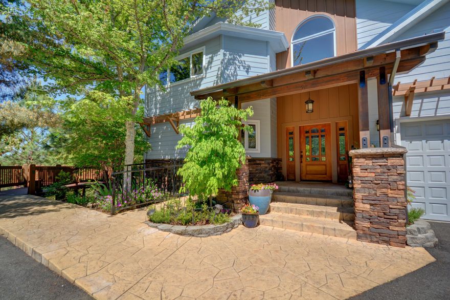 Views, trees, privacy and a slice of heaven just minutes to town! Built in 1992 by Bob Volkman, this custom Home has been lovingly cared for and maintained by the original owners. The features and attention to detail in this 3,608 sq ft. home & property are too many list, you will have to view it to appreciate all that's here! Grand front porch welcomes you inside to vaulted ceilings, gorgeous woodwork, beautiful hardwood floors & open staircase. Expansive windows throughout allow you to enjoy the views, as well as bring in natural light. Wrap around decking provides opportunities for outdoor gatherings. You'll have everything you need on this 6.17 acres! In addition to a 2 car garage, there are two additional garage/shop areas, greenhouse, deer fenced garden area and fenced pasture. District 7 schools, close proximity to Grants Pass Golf Course and Hospital complete this perfect location. Don't miss out on the rare opportunity to own this one-of-a-kind Home!