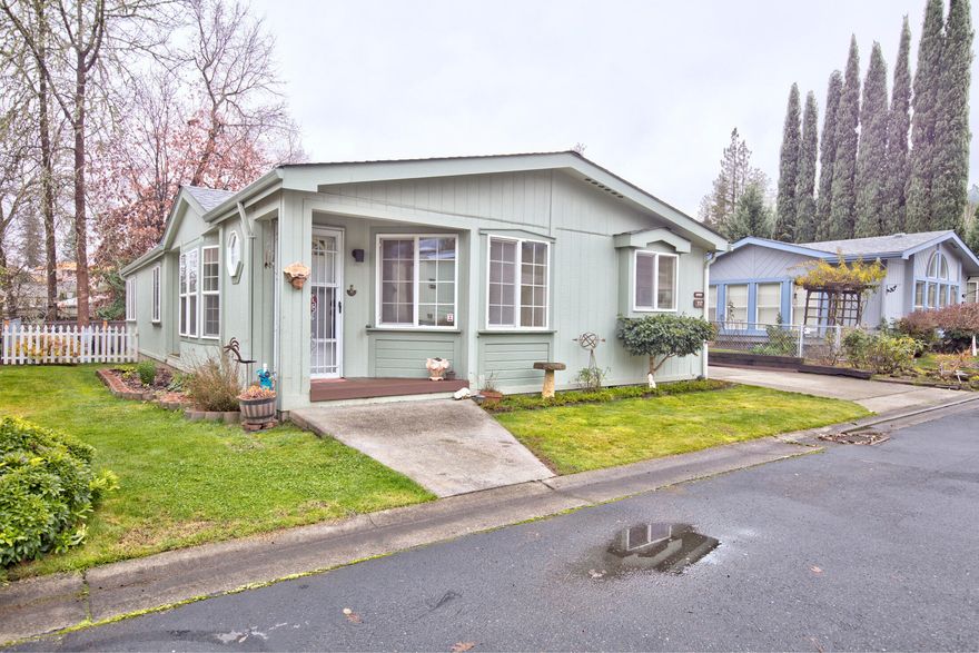 Located in a NW Grants Pass premiere & beautifully maintained 55+ park. From the moment you walk into the entry way, you are greeted by a beautifully maintained, light and bright home. Pride of ownership is evident in every corner. The home has new laminate flooring throughout the unit, new refrigerator, dishwasher, kitchen pull-outs, upgraded lighting fixtures, and many additional improvements such as sinks, vent covers, faucets, and interior paint. The roof was replaced in December 2018, including skylights, and new gutter guards. The Primary bath has a jetted tub and walk-in shower. The convenient laundry has extra storage, complete with washer & dryer. The home sits on a large lot with fenced backyard, raised planter and garden area, covered patio, and large deck that can be accessed by primary suite. Space rent is $700/month and includes water, sewer and trash. Come see this very special unit in a very special park. One year home warranty provided.