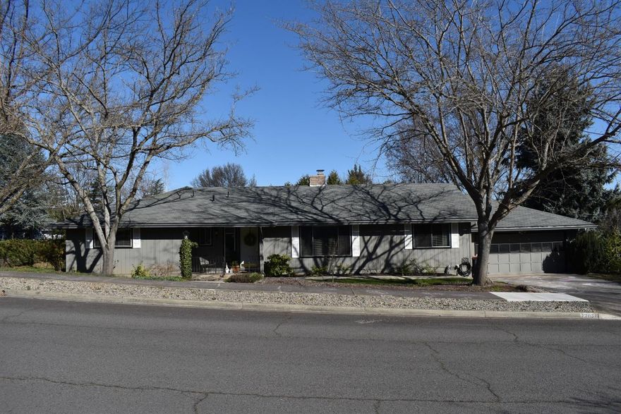 Lovely East Medford property in a quiet, low traffic neighborhood in the Lone Pine School District. Home has 4 large bedrooms and 2 full bathrooms. 4th bedroom has a wall of wood accordion doors that open up to the dining area making it great office or family room as well. Corner lot property with low maintenance landscaping on a dead end street. Nice sized indoor laundry room with tub sink and pantry. Kitchen overlooks the backyard and has a dry bar that opens up to the den or formal dining room. Living room has large window and large brick fireplace.
