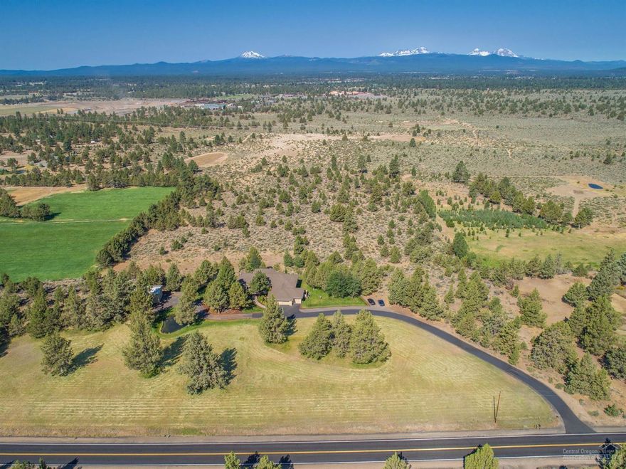 Perched on the ridge overlooking the lower terrain of this 20 acre estate site w/unobstructed Cascade mtn views from Bachelor to Jefferson, this well designed single level home is positioned for privacy. A perfect floorplan w/2839 SF of open, bright living space w/9' to 12' ceilings, 3 beds, 2.5 baths, den/office, great room w/FP, big kitchen w/eating bar, center island & breakfast nook & dining room. Plus 1156 SF attached garage & 24x36ft RV garage/shop w/12ft door. Irrigated field, water feature & ponds.