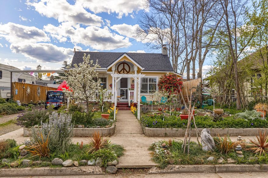 Adorable, cozy & charming home! This 1920's craftsman is 1264 sq feet, 2 bdr 1 bath with a small office area and has been beautifully updated with an open kitchen, granite counter tops, an island and a ton of storage. With a bright & sunny disposition, hardwood floors throughout, tall ceilings, large windows and an open feeling floorplan this home is wonderful place to keep your indoor plants happy as well as enjoying a cup of morning coffee in the dining room window seat. The bathroom has been nicely updated with an oversized tile shower, new vanity and flooring. Outside is a gardeners delight with raised beds, plants, flowers & trees. In addition, there is potting shed and a ''Music Cave'' both structures have power. The Music Cave would make a great studio ADU (check with city of Medford for permitting and uses). New exterior paint, roof and HVAC system 2019. This is a must see home!