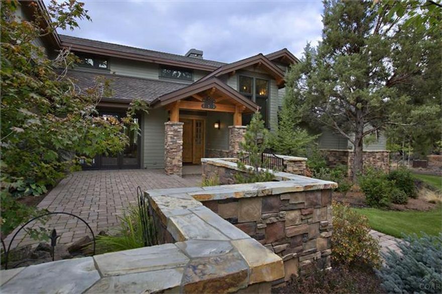 Sitting at the back of the 23 acres is a gorgeous custom home. The paved driveway winds among the stately ponderosa pines. Enter the home thru the stacked rock courtyard and you will be greeted with rich hickory wood floors, natural stones & solid 9 ft. wood doors. The custom kitchen is amazing. Beautiful master suite on main level, wine cellar, large laundry room, big back deck to take in the views or enjoy the hot tub. The manicured grounds have automated system, pond and lots of natural space.