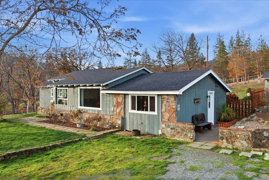 This lovely property has so much to offer! This ranch style home is 2541 SF and has 5 bedrooms and 2 bathrooms. It additionally features a family room, living room, and dining area. The kitchen is spacious with abundant cabinetry. Recent updates include a brand NEW 66X24 2 CAR GARAGE plus shop, newer roof and septic system, newer well house and pump, new electric panel, new ductless mini-split, and a new wood-burning fireplace! Too many updates to list. The home offers garden beds, a private patio area, and an IN-GROUND POOL with new heater perfect for summer fun. The 1.83 acres is completely fenced and gated with plenty of room for animals, this property has the perfect amount of usable land and elbow room. This well-maintained property combines rural living with modern updates and plenty of space for your lifestyle! A drive to Grants Pass takes less than 10 minutes, making this gem of a  property extremely accessible and convenient without sacrificing that country feel.