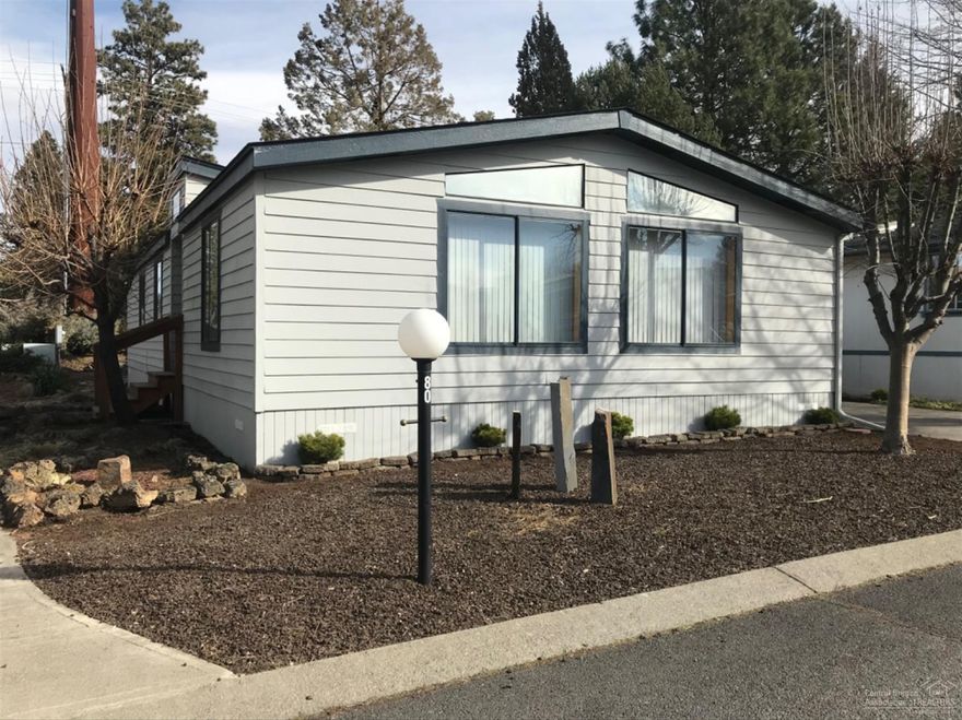 Great home with lots of windows and plenty of storage. Newer laminated floors, furnace, heat pump, appliances, plumbing and toilets. Updated plumbing under home. Stall shower with seat. Walk-in closet. Very low maintenance yard with beautiful flowers and walkways. New fence in the back yard. New exterior paint. Home looks great. Carport big enough for 3 cars with awnings and large storage shed. 55+ park close to senior center and walking trails. Clubhouse with pool tables, wood stove and lots of activities. Friday night BINGO. $461 monthly space rent includes water, garbage, sewer and yard debris removal. NO SUBLEASE. All occupants need park approval with credit and background check. Move in ready. Welcome to Suntree Village!