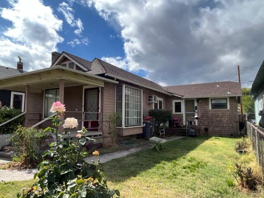 Single level Craftsman/Bungalow style home/duplex with 1606 combined square feet, new roof & lots of charm from 1910! Main Unit has a great covered front porch and interiors 2 bedrooms, one bathroom,  fir floors with fireplace, living room, dining room, kitchen and eating area in kitchen too. This unit also features an attached garage and off street parking in the back alley. The 2nd unit has been occupied long term (20+ years) by same tenant and this unit features one bedroom, one bathroom and a carport. Both units share the laundry room which is in between the 2 units. Both units do have deferred maintenance and Seller is selling in ''as is'' condition.