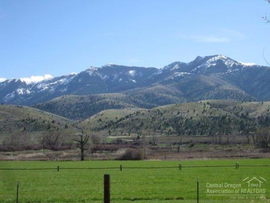 Moon Creek Road River Ranch! Located near Mt Vernon, Oregon, 166 acres with John Day River frontage, spectacular mt views, private & serene setting, Quaking Aspen lined gravel driveway, fenced & cross fenced, 57 irrigated acres yielding approx 60 ton of grass hay, metal pole barn, calving barn w/stalls, barn, 3 bay machine shed w/attached shop, large Quonset shop, 2 metal containers, 3 bed 2 bath mf home, old ranch house qualifies for replacement dwelling permit, fruit trees, fenced garden. $490,000 #918