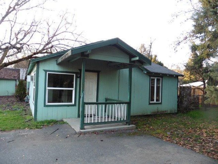 Cottage style home on large .30 acre lot zoned R-2 offers great potential. Buyer to do their own due diligence for use of property. The small cottage offers a bonus room that could be a nice office /craft room. Home also features a dining room plus enclosed service porch. The detached garage has a shop area, paved driveway allows a turn around space. With some TLC this could be the home it once was.