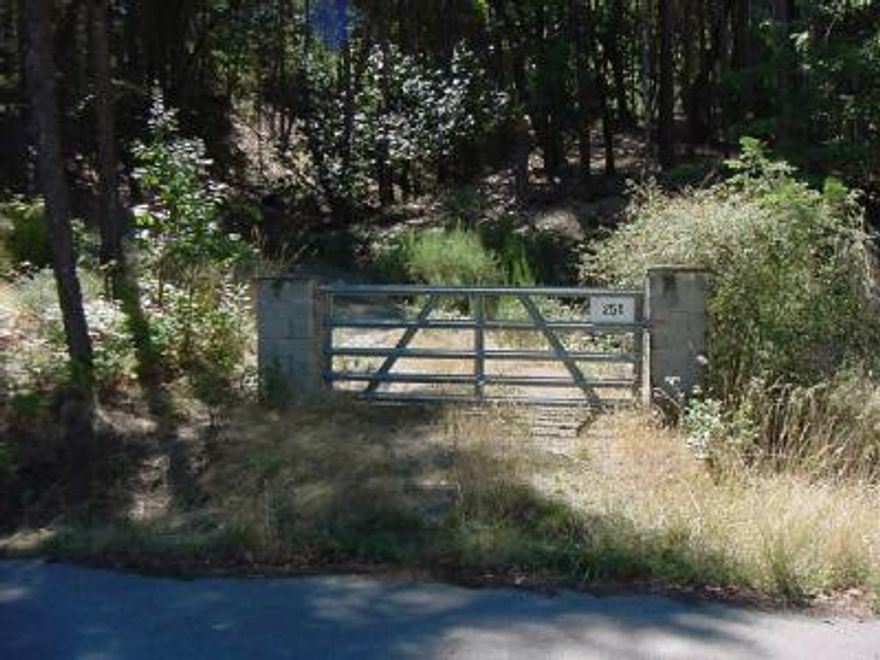 Exclusive area of fine homes with total privacy. 4 bedroom septic w/tank installed. 10GPM well. Gated driveway w/pillars wired for lights. Driveway to homesite has wiring for lighting. Power to homesite pad. Property lines are flagged. Current homesite approval per owner.