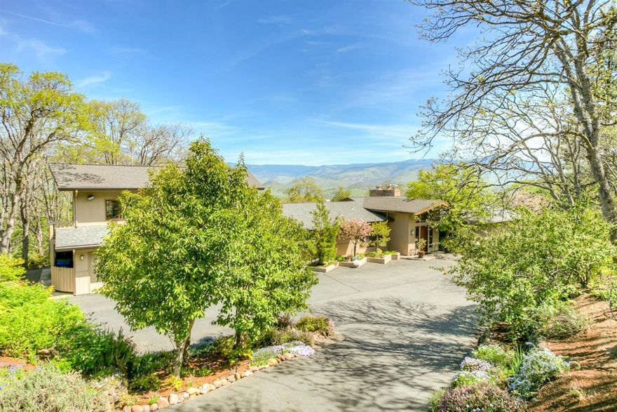 Rare opportunity! Stunning mid-century estate on over 4 irrigated acres in the city limits. Vaulted great room boast wide plank Cherry floors, oversized wood burning fireplace with detailed stone surround & convenient access to the gourmet kitchen complete w/ rainforest marble counters & backsplash, Dacor & SubZero, operable skylights, walk-in pantry & outrageous views of Grizzly Peak. Wet bar, formal & informal dining. Several en-suite bedrooms, a library w/ fireplace, lower level family room with built-in entertainment center. 3 car attached garage w/ 1 bed, 1 bath guest apartment overtop. In-ground pool, Koi pond with cascading water feature. Stone paths and walls highlight the mature landscaping. Total privacy. TID irrigation. City water & sewer, high speed internet. Gated drive.