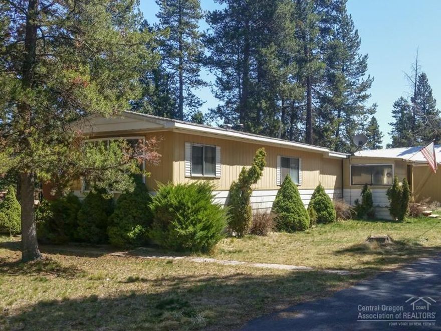 Great Opportunity to own a home on a 1.11 acre lot in Central Oregon. 1978 Marlette Mfg home features 2 bedrooms, 1 bath, kitchen, living room, covered back deck and nice sitting patio. Newer Septic and Well installed on the property. 576+/- sf RV Storage Pole Barn, 1200 +/- 3 car garage/shop, garden/wood shed. Property is fenced with a paved driveway and on a quiet road. Home is furnished.