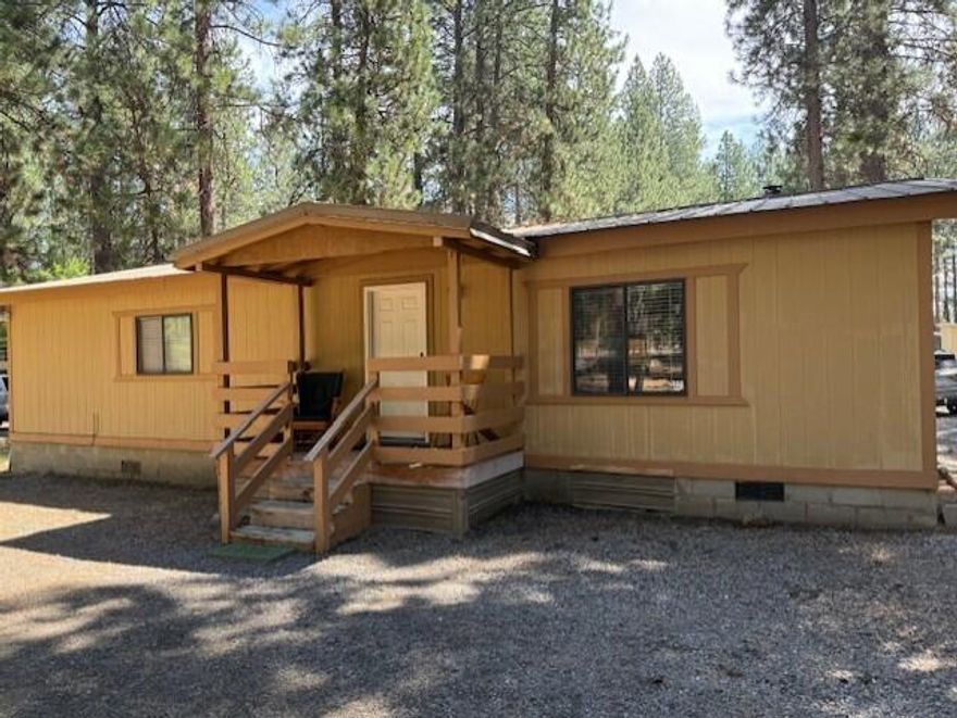 Live the Central Oregon dream on over an acre in beautiful Bend! This somewhat updated manufactured home welcomes you with stylish laminate flooring, fresh interior paint, and a bright, comfortable layout. Outside, there's space for all your toys—boats, RVs, trailers, and extra cars—with easy access on a paved street. Just half a block from Lava Lands, you can step out your door and into some of the area's most stunning natural landscapes. Detached double garage. Whether it's a weekend of exploring, a quiet evening under the stars, or hosting friends in your spacious yard, this property delivers the perfect mix of adventure and comfort. This property is tenant occupied and has some deferred maintanance. Reach out to your favorite agent for more details.