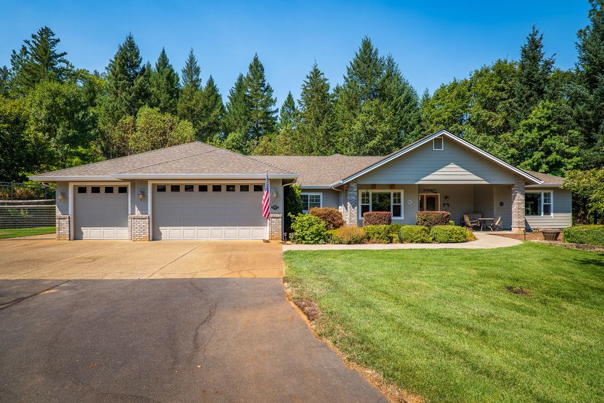 Need parking for 10 vehicles? Welcome Home to Red Rock Lane! Located in the desirable Whitestone neighborhood, near the Rogue River, in the Riverbanks area of Grants Pass. This custom built 4,000 square foot home features 3 bedrooms, 2 baths, formal dining, open living and kitchen spaces, and a spacious sunroom with a wood stove. If the attached 3 car garage doesn't allow room for all of your toys, there is a detached garage w/ space for an additional 7 vehicles as well as your RV with a 14 foot door! The primary suite is located on one side of the home & features 2 walk in closets, jetted tub, huge walk in shower, & private water closet. A hot tub rests on the private patio off the primary bedroom. Custom tray ceilings, plants shelves, & storage flank the home and the guest bedroom features its own enclosed patio room. The 4.7 acre property also features a gated entry, enclosed garden space, and enclosed yard for pets. The entire property is fenced w/ a strong well. Call toda