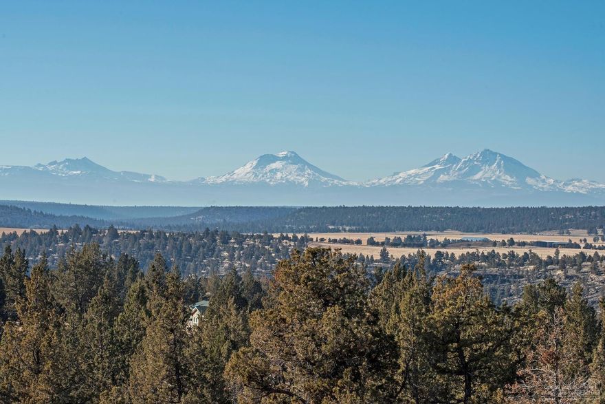 WOW! Spectacular view of the Three Sisters & the Cascade mountains right out your front windows. Imagine the alpine glow at sunrise and the spectacular oranges and reds of sunset behind the mountains. It fills the soul with amazing vistas every day. Open, sun-splashed interior with huge kitchen. A third bedroom is upstairs for added privacy with the master and guest room on the main floor. Huge shop/garage with tons of counters and shelving along with a guest, hobby or office that includes a bath for lots of options. Beautifully designed with oodles of outdoor spaces that include a hot tub, easy care landscaping and fire pit. And all that Crooked River Ranch has to offer: golf, tennis, swimming, hiking, abundant wildlife & rich community life.