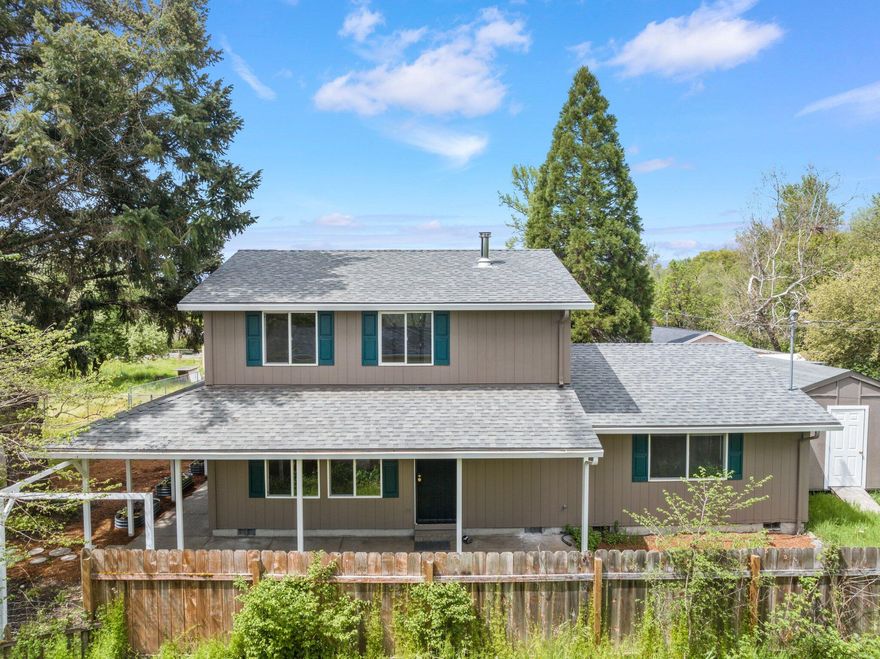 Welcome to your dream home nestled in a serene setting! Surrounded by nature's beauty, and close to the many luxuries Southern Oregon has to offer! This home is full of charm and includes 3 bedrooms, 2 bathrooms, offering 1,680 well-utilized sqft. and situated on a spacious .21 acre lot. Downstairs is the kitchen, living area, 2 beds, and laundry room.  Upstairs has a very spacious primary bedroom/bath with another room attached that could be used as an office, hobby room etc. Countless updates have been made, such as a brand-new roof, gutters, flooring throughout, exterior/interior paint, kitchen countertops, just to name a few. Front yard has been wonderfully landscaped, outside has two storage sheds one w/insulation and extra wood storage for the stove! This property backs up to the enchanting Louse Creek! Entertain guests with the ample backyard space and enjoy the sound of the creek right in your backyard! Lastly, this home offers Free Municipal Water! Schedule a showing today!