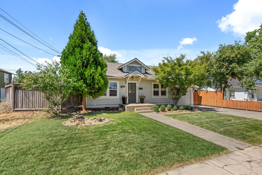 Searching for character? This home perfectly blends vintage appeal with modern functionality. The inviting entry room features a gas fireplace, custom built-in shelving, and a passthrough window to the kitchen. The main floor primary suite includes an en-suite bathroom with dual vanities and generous closet space. The sun-drenched dining room is ideal for meals and gatherings with easy access to a patio seating area. The kitchen offers a gas range, built-in microwave, and is conveniently located next to a large walk-in pantry/laundry area complete with a sink. Upstairs, you'll find an additional bedroom and flex space perfect for an office, hobby room, or guest area. The back living room opens to a covered deck/patio, leading out to a shaded backyard. Additional features include a one-car garage and a spacious shed, ideal for storage or a workshop. Enjoy comfortable, functional living with the preserved character of the original 1930s build.