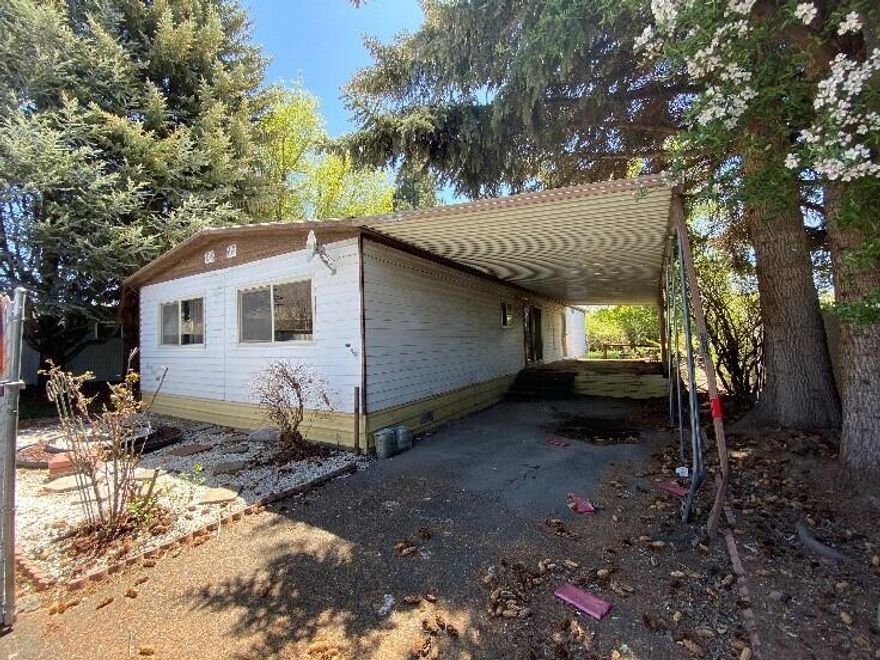 Very private lot tucked away in the middle of the suburbs. Fully fenced with secure parking, shade trees and garden area. Buyer discretion on the state of the manufactured home.  Well built, raised 10 X 20 shed could be the workshop needed to rehab the property.  Property was vacated almost a year ago and winterized.  Utilities are now on and functional.   Less than a mile to Walmart or South Sixth St. Might be an investor/flipper opportunity.