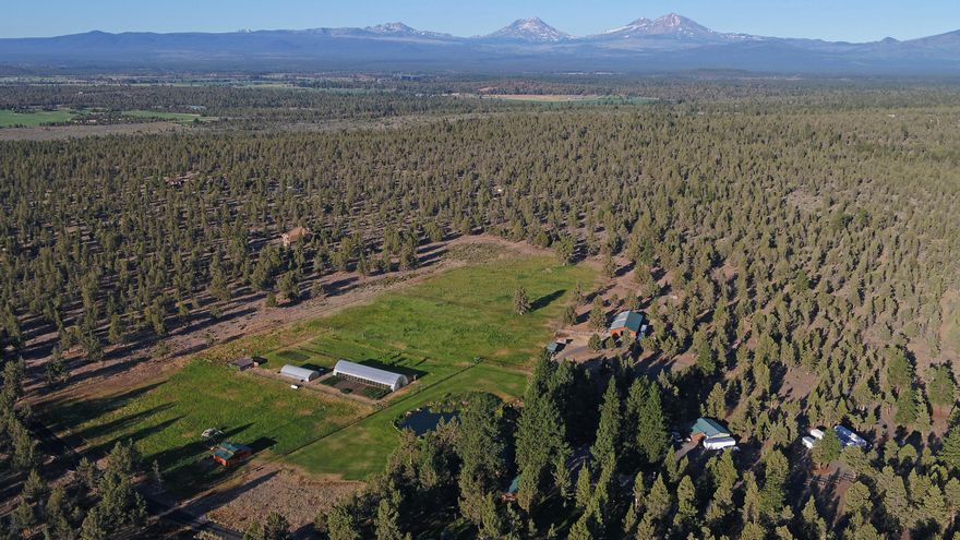 One of the most spectacular properties in Central Oregon. Grow your own food (2 commercial grade greenhouses/goat barn/etc), with abundant recreation on (7 stall horse barn/swimming ponds & pool/etc), and from this completely private end-of-the-road farm compound. Surrounded on 3 sides by 1000's of acres of BLM/Public land with direct access to many miles of secluded horse, motorcycle, hiking trails and Whychus Creek swimming holes. Huge Cascade Mountain views from house & property. Fully paved access. Total of 80 acres includes adjoining 40 acres of buildable land (70055 Goodrich) with big views & public land access. See attached property features document for numerous features & amenities.