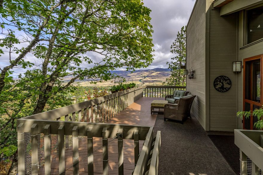 A Sanctuary! Private Home with Panoramic Mountain Views in Ashland's Finest Close-in Location. This hidden gem is surrounded by towering trees, two levels of outdoor decking, meticulous landscaping and a soothing water fall to enjoy year-round. The main level features a vaulted living area with ''wall of windows'' views, a ''tree-house'' dining area, Mendota fireplace, and an inviting, open kitchen with loads of counter space and cabinetry. It's just steps to the large master suite with dramatic windows and natural views, sitting area, and vaulted bath with large soaking tub, double closets, privacy commode and great built-ins. There's separate lower-level living including a family room with fireplace, two guest bedrooms, 1-1/2 baths AND an amazing office/bedroom with large corner windows to take in the natural terrain and bubbling fountain. Wonderful storage includes a detached double garage with lower level workshop and plenty of room to expand the home's ground level. A True Oasis!