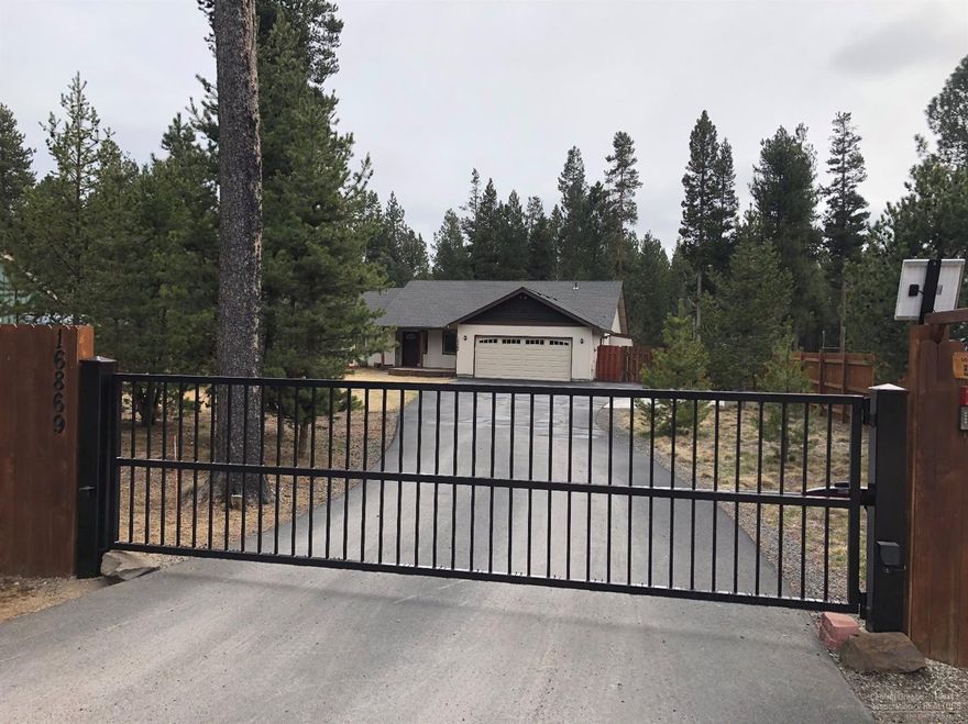 Looking for over 1/2 acre of flat land, fenced, landscaped with gated entrance just minutes from Sunriver, Mt. Bachelor and the High Cascade Lakes? This 3 bedroom 2 bath + office/den area is just waiting for you. Great room with vaulted ceilings, skylights, floor to ceiling fireplace all updated, wall of windows looking to the fenced landscaped back yard with new 700 SF Trex deck and mature pine trees. 200 SF cedar pergola front deck with rock beds front and back yard. 196 SF storage shed with loft. Newer appliances, newer laminate floors, newer carpet. Come take a look.