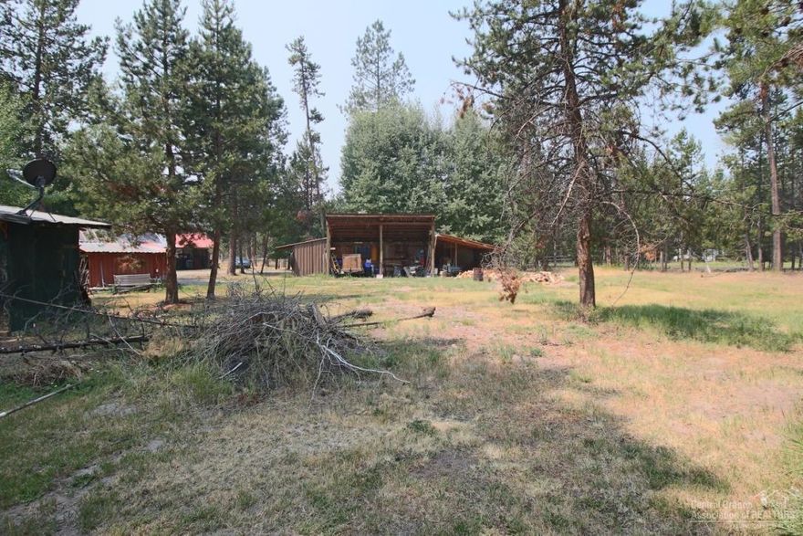 Can you believe a 1,584 square foot home with frontage on Little Deschutes River on almost 6 acres (approx. 5.71 acres) and on a paved road for under $400,000? The location on Lazy River Drive is perfect to for easy access to the lakes, Mt. Bachelor and to Sunriver. There are several outbuildings and a green house to start all your plantings early. Come and see this opportunity to have your own get-a-way. The gorgeous Acacia wood floors were just installed, Hickory cabinets, 2 separate tax lots.
