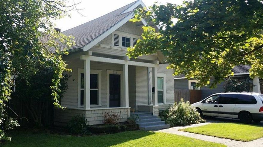 Charming 2 bedroom, 1 bath Craftsman cottage plus bonus room/office, w/ covered front porch, features beautiful refinished oak hardwood floors, new tile & vinyl flooring, vinyl windows, insulation, central heat & air, fresh paint inside, & exterior trim. The kitchen features an original china hutch & newer appliances, incl. refrigerator. There is a built-in linen closet in master bedroom, fireplace in living room & original claw-foot bath tub in updated bath. Home is sunny & bright w/ a slider in the living room that opens to a patio. Wood blinds, roller shades & roman shades stay w/ house. Laundry room furnished w/ washer & dryer & lots of cabinets for storage. Front porch is perfect for enjoying this family-friendly neighborhood. Back yard has easy-maintenance landscaping w/ auto sprinkler system, & is completely fenced. Covered back patio and huge 2-story shop - any guy's dream! Driveway is fully paved w/ front and alley gate for E-Z access. Home warranty included!