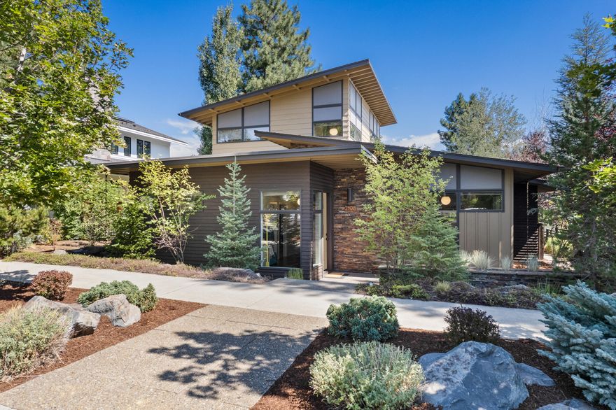 This stunning Greg Welch-built home seamlessly blends mid-century style with contemporary features. Offering 2,001 sq ft of thoughtfully designed living space, this residence is nestled on a remarkably private lot near shops, restaurants, schools, and trails. The main level features two bedrooms and a fully remodeled bathroom with a stylish soaking tub. The refreshed kitchen boasts a bespoke chef's pantry, refinished cabinets, and new lighting. The great room showcases a contemporary stone fireplace with a broad hearth, creating a warm and inviting ambiance. Upstairs, the primary suite serves as a light-filled retreat with expansive windows, a private rooftop deck with treetop views, and a luxurious en-suite bath with a walk-in closet. The back patio, complete with a hot tub, provides an ideal outdoor oasis. Earth Advantage certification, solar panels, and integrated smart home technology round out this impeccably maintained sanctuary perfectly combining efficiency and elegance.