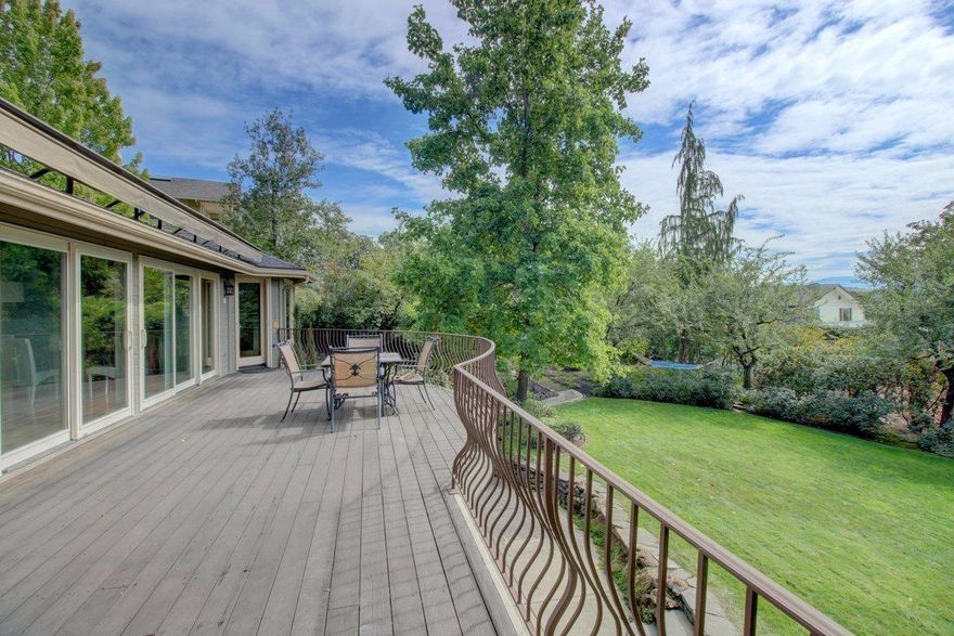 Stunning Pagnini built home on a lush park-like .56 acre lot with a private setting in East Medford! 3346 sqft 4 Bed 2 1/2 Baths plus an office. Beautiful Kitchen w/ breakfast nook, custom cabinets, stainless appliances, large island, & granite counters.Open living/dining area w/ coffered ceilings, gas fireplace, and floor to ceiling windows w/ sliding doors lining the wall and opening to the deck. Huge Deck offers great views perfect for afternoon BBQ's or taking in the park like setting & beautiful views. Large Master bedroom on the main level with large closet, soaking tub, shower and private entrance to the patio & hot tub. Professionally designed landscaping including huge yard, wisteria arbor, garden, & water features & a trail! Daylight basement with 3 large bedrooms, a full bath and additional bonus/ family room currently used as a theatre room. Other features include hardwood floors, deck awning, tons of storage areas, tree lined entrance with pavers and room for a boat or RV