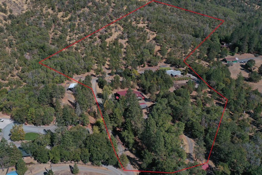 This Property has it all! Gorgeous HOME,  2 SHOPS, GUEST house, out buildings galore, 11.47 acres, GOLD MINE w/half mineral rights & Views, Views, Views. Remodeled home in 2016 & 2021. The kitchen features white shaker cabinets, walk-in pantry & beautiful laminate floors. The kitchen opens into the spacious dining room w/ large picture windows. The living room is large & inviting w/ large skylights that brighten the room. The Primary bedroom has 2 walk-in closets & a large en-suite with a double vanity. The grounds have been set up for entertainment & get-togethers. You will find a large covered front patio looking out onto the expansive views has room for BBQ's & tons of seating. Enclosed gazebo. Fenced garden areas. Near the home you will find a garden shed, 2 carports & a 22 x 20 shop completely insulated w/ electrical! Down the circular driveway you will find a huge SHOP! Almost 5000 sq. ft. (per seller) under one roof, includes shop,lean to & guest house. See attach feature list