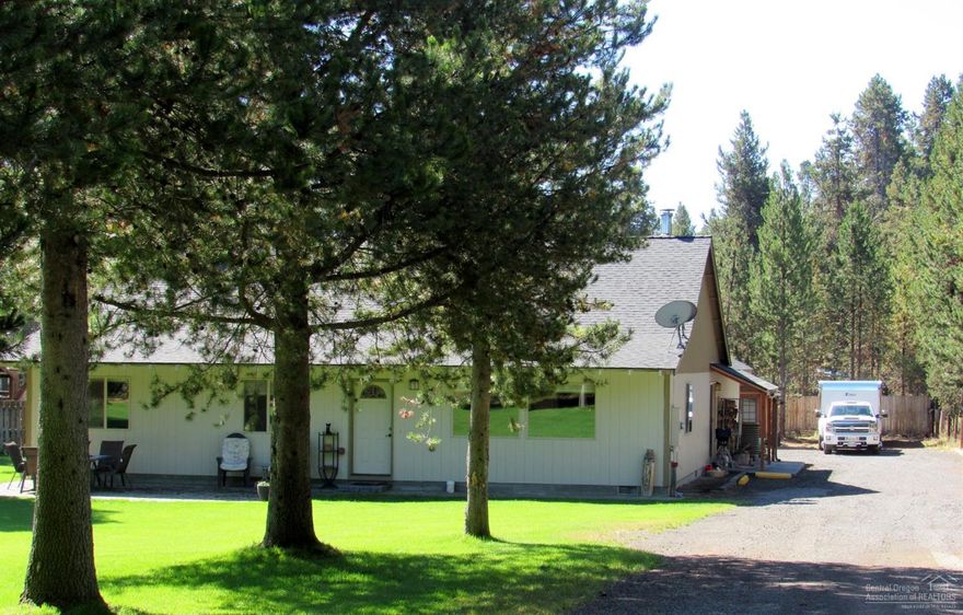 Spacious, Comfortable 3 bedroom home with den, attached 2 car garage, fenced fire pit area, 3 bay carport perfect for your toys & tool shed sit on completely fenced property with lush green lawns. Front Patio area is a great place to relax. Spacious open great room, includes; Kitchen with eating bar, granite countertops, stainless steel appliances and large pantry. Picturesque windows in the living room, vaulted ceilings, eating area and woodstove. Wide hallway leads to 2 spare bedrooms and master bed and bath with large walk in closet and jetted tub in the bathroom. Sprinkler system.