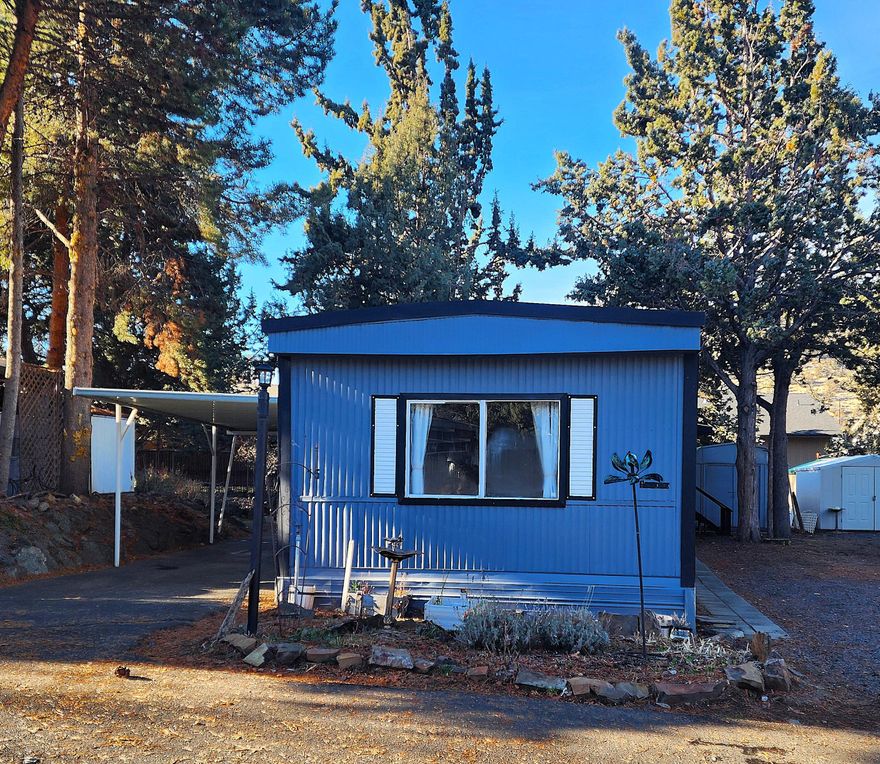 Affordable, cute single wide home in quiet, friendly, 55+ Rock Arbor Villa.  Tons of upgrades in the last year, including kitchen countertops, sink, dishwasher, refrigerator, primary bathroom with complete makeover including a brand-new, walk-in tile shower, new wood stove, secondary bathroom, paint, and more!  One bedroom and bathroom at each end of the home for privacy.  Generous sized extra parking area in addition to carport.  2 sheds for extra storage.  Home is located at the edge of the park and has a partially fenced back yard.  Sold AS-IS.  Space rent is $585/month and includes water, sewer, garbage, clubhouse, seasonal pool, and snow removal. Great location!  No dogs.  Come check out this cozy home!