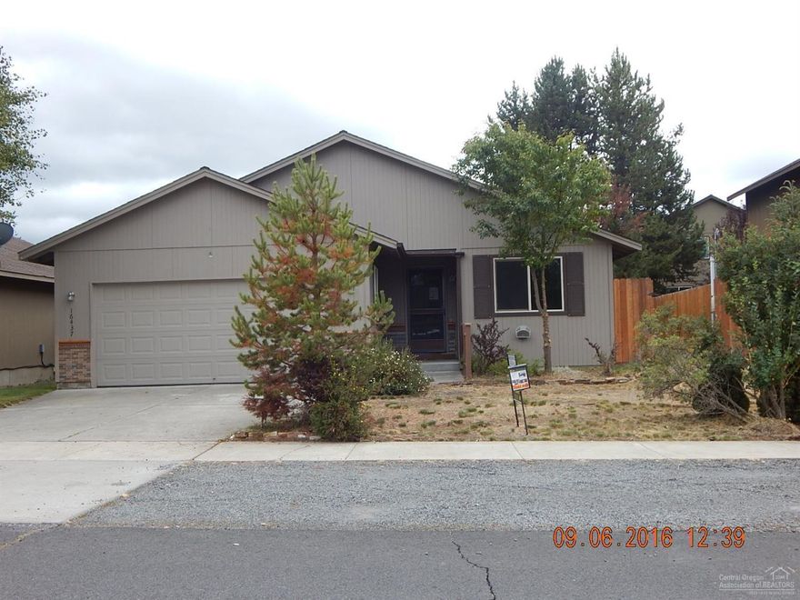 Great value here in this 3 bedroom, 2 bath home with in-town location. Fenced yard with storage shed and deck in back. Attached double garage, great room concept with dining, living room and kitchen in one room. Vaulted ceilings, ceiling fans, and inside laundry area. Kitchen has an island, white microwave, range and dishwasher. Needs some TLC, priced right!